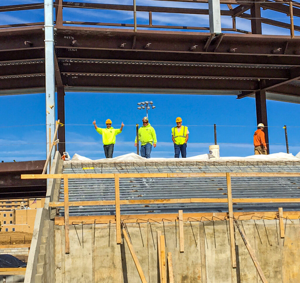 construction workers working on a college football stadium